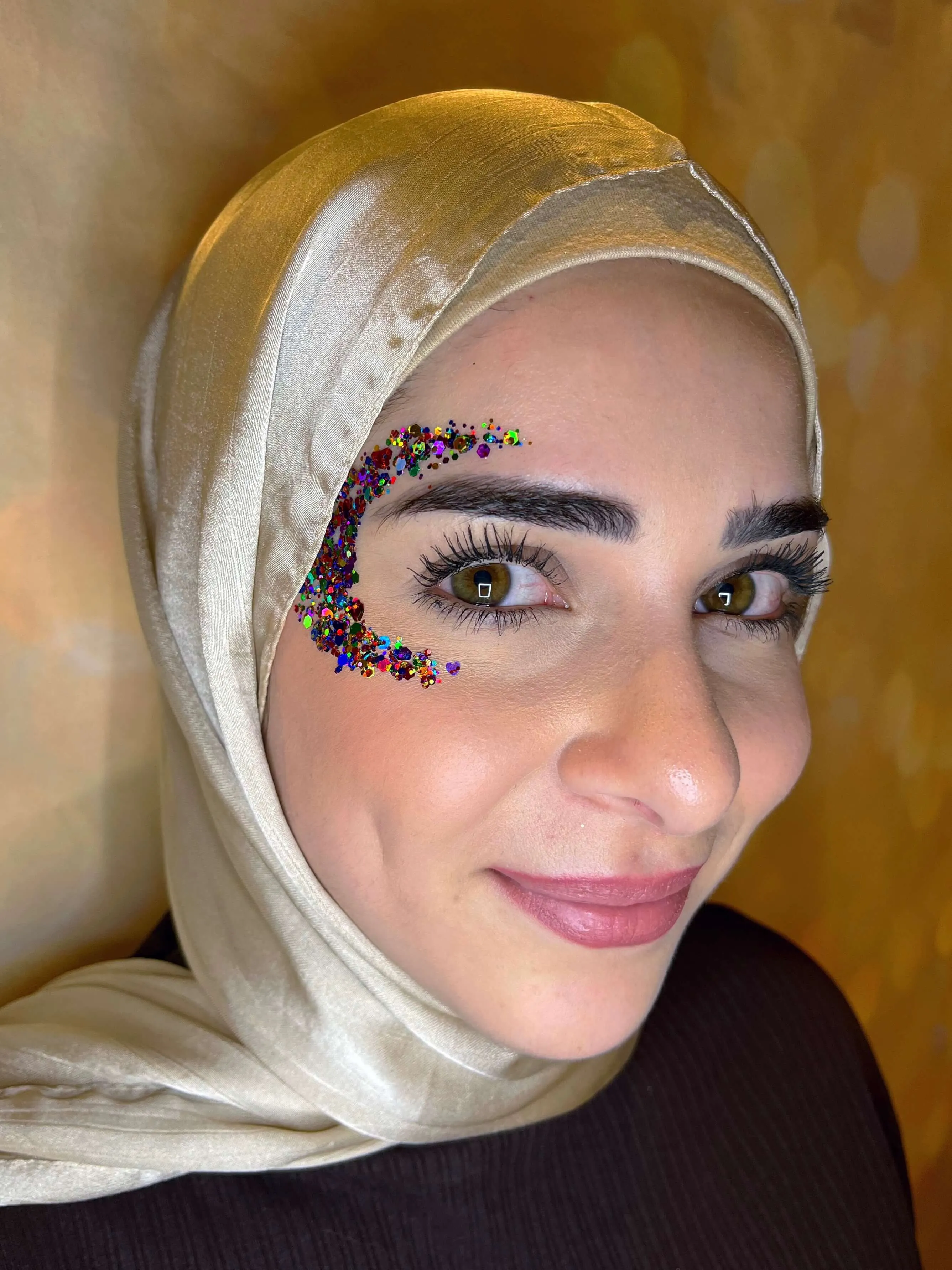 A beautiful face adorned by intricate glitter art