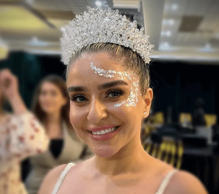 A beautiful face adorned by intricate glitter art.