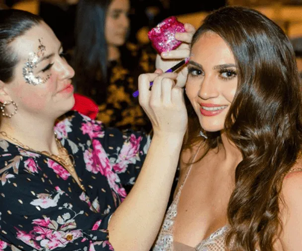 A beautiful face adorned by intricate glitter art.