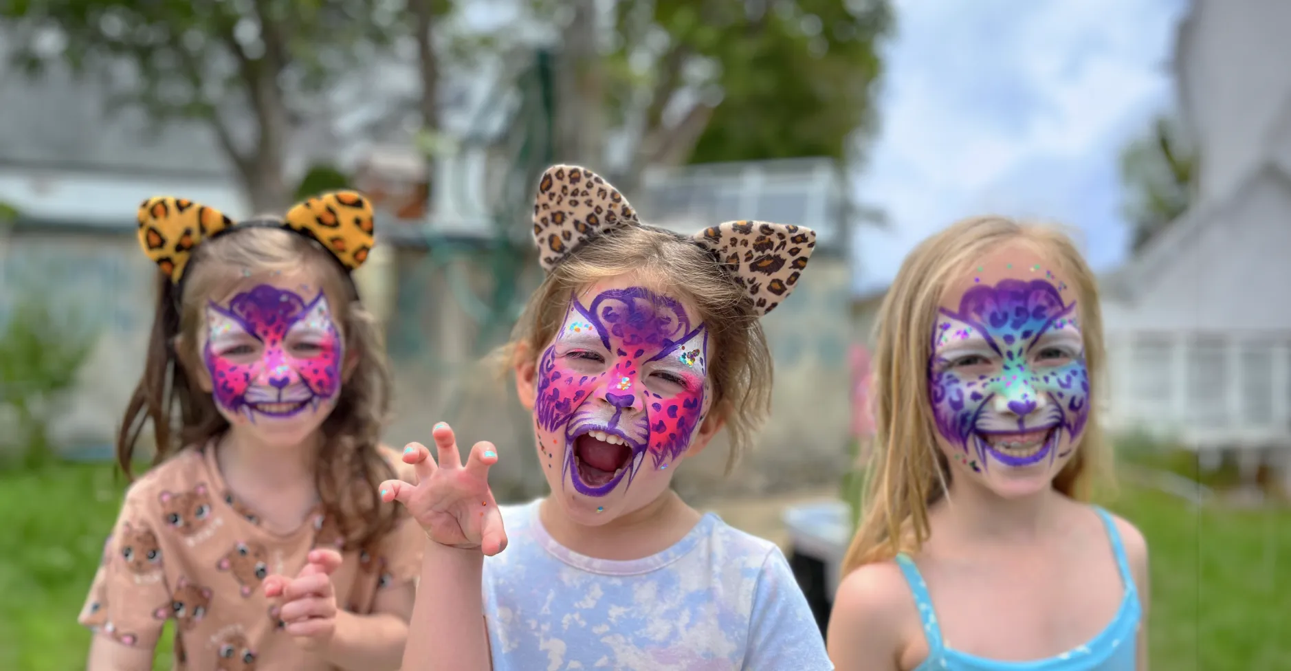 Kids proudly displaying an amazing facepaint artwork
